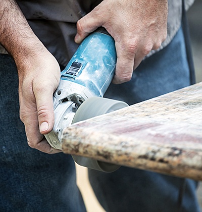 Man polishing tan granite countertops