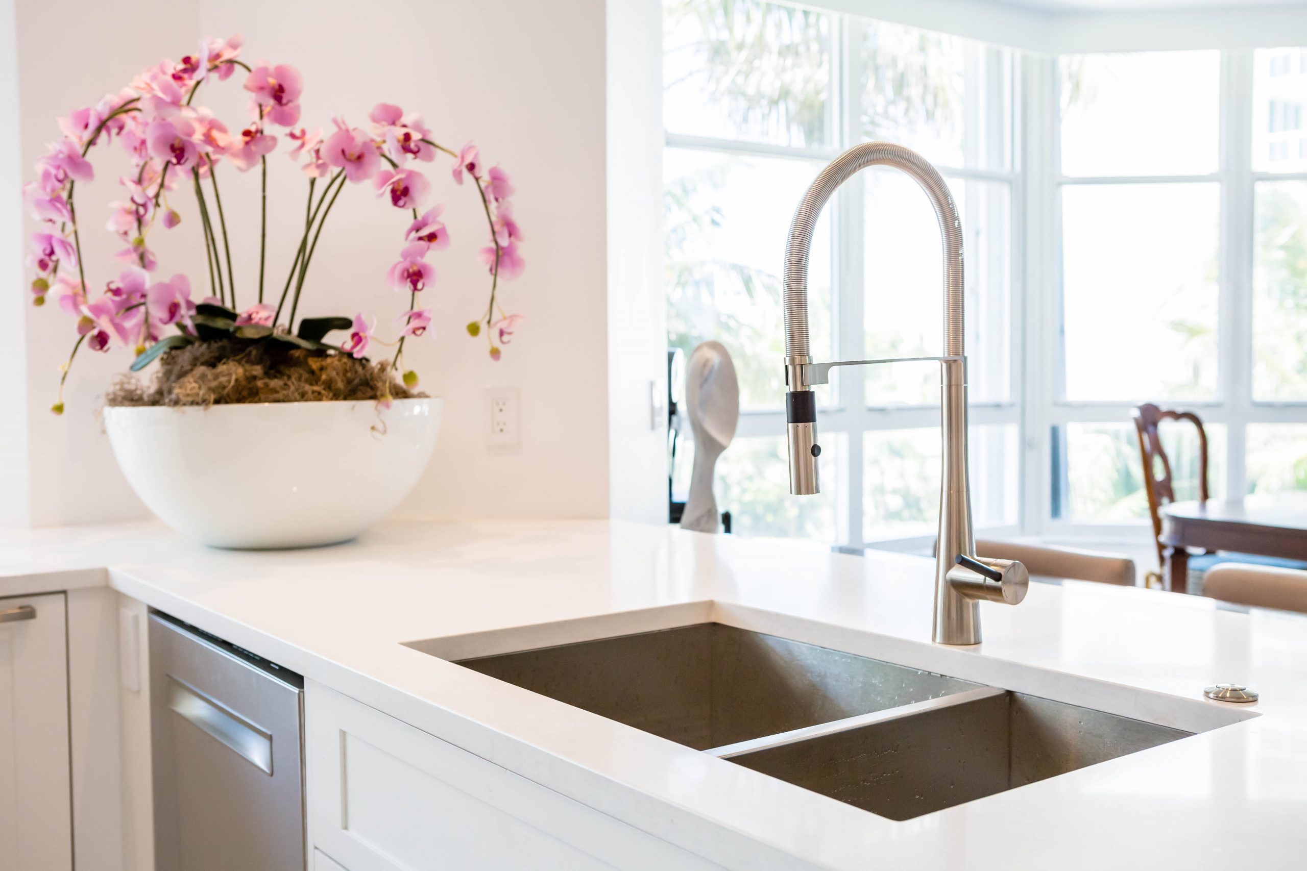 white marble kitchen countertops with sink and pink orchid